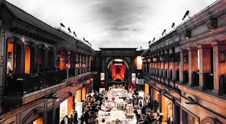 Interior view of a vibrant shopping area with various service stalls and customers.