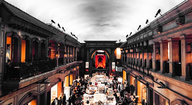 Interior view of a vibrant shopping area with various service stalls and customers.