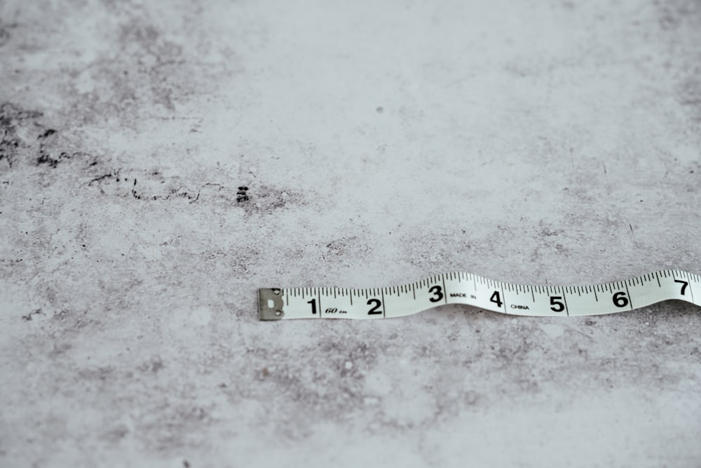 white measuring tape on white surface