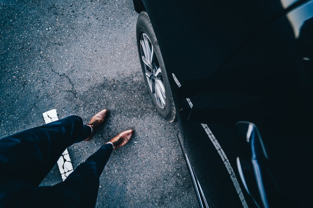 person standing near car