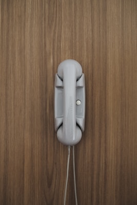 gray home phone on wall