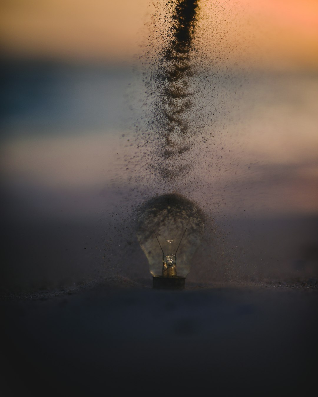 light bulb sprinkled with sand