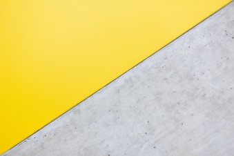 a close up of a yellow and white wall