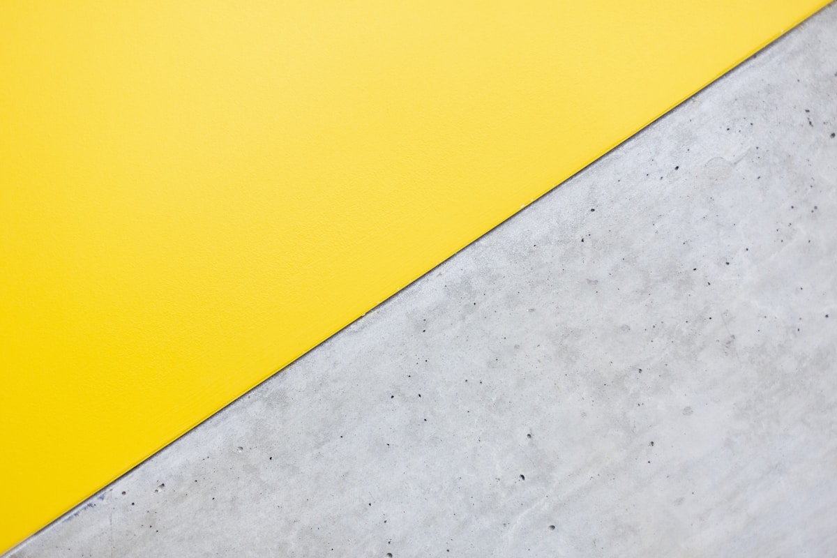 a close up of a yellow and white wall