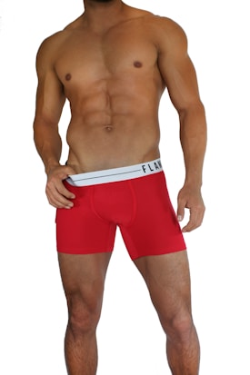 A muscular male torso is displayed, wearing bright red boxer briefs with a white waistband. The waistline of the briefs has a brand logo visible on it. The skin tone is tanned and the individual is posed in a confident stance.