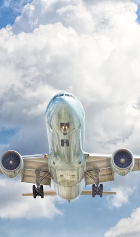 gray and white airplane on flight near clear blue sky