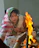A warm, smiling woman participating in a live online pooja from her home.