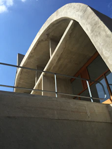 Modern architectural blueprint overlaying a sleek concrete building facade.