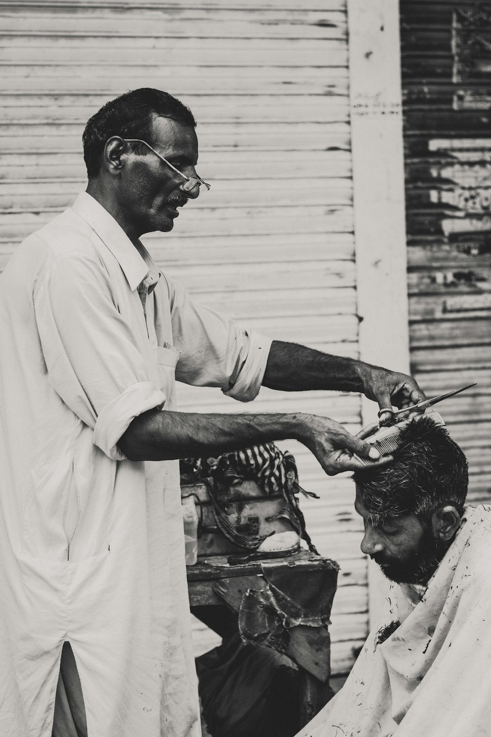 man cutting another man's hair