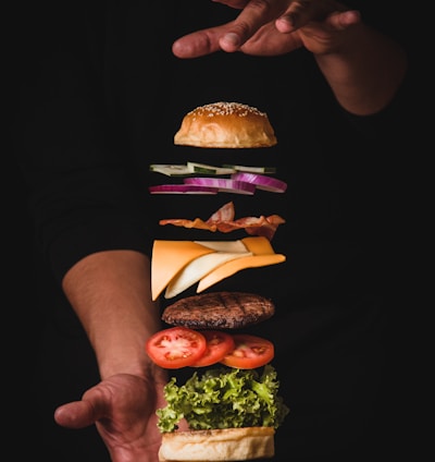 timelapse photo of man holding burger