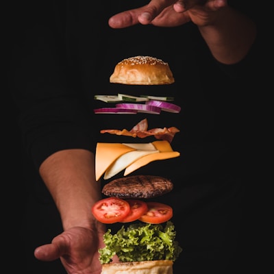 timelapse photo of man holding burger