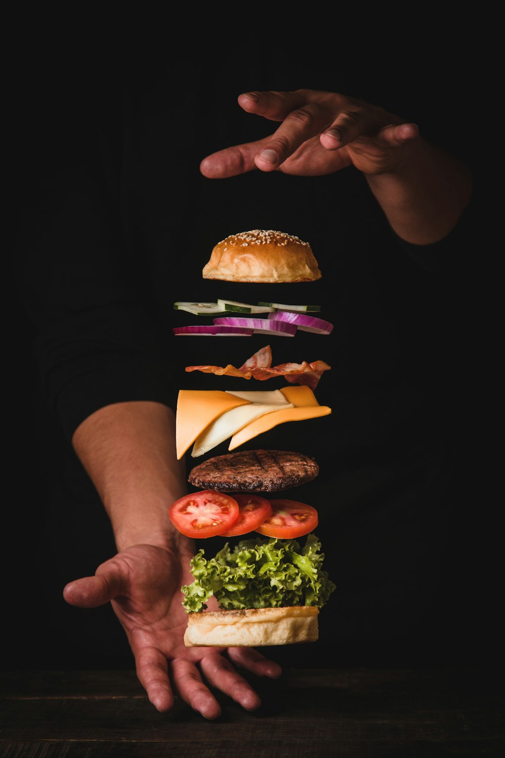 timelapse photo of man holding burger