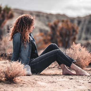 woman sitting on brown soil