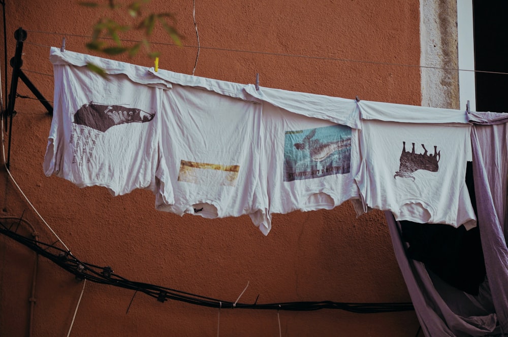 several white shirts hand on clothes wire