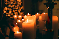A beautifully arranged collection of celebration candles glowing softly in a cozy setting.