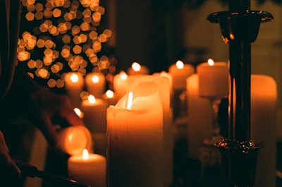 A beautifully arranged collection of celebration candles glowing softly in a cozy setting.