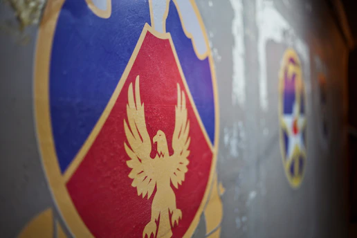 A close-up of a Knights of Columbus emblem embroidered on a blue jacket, symbolizing brotherhood and faith.