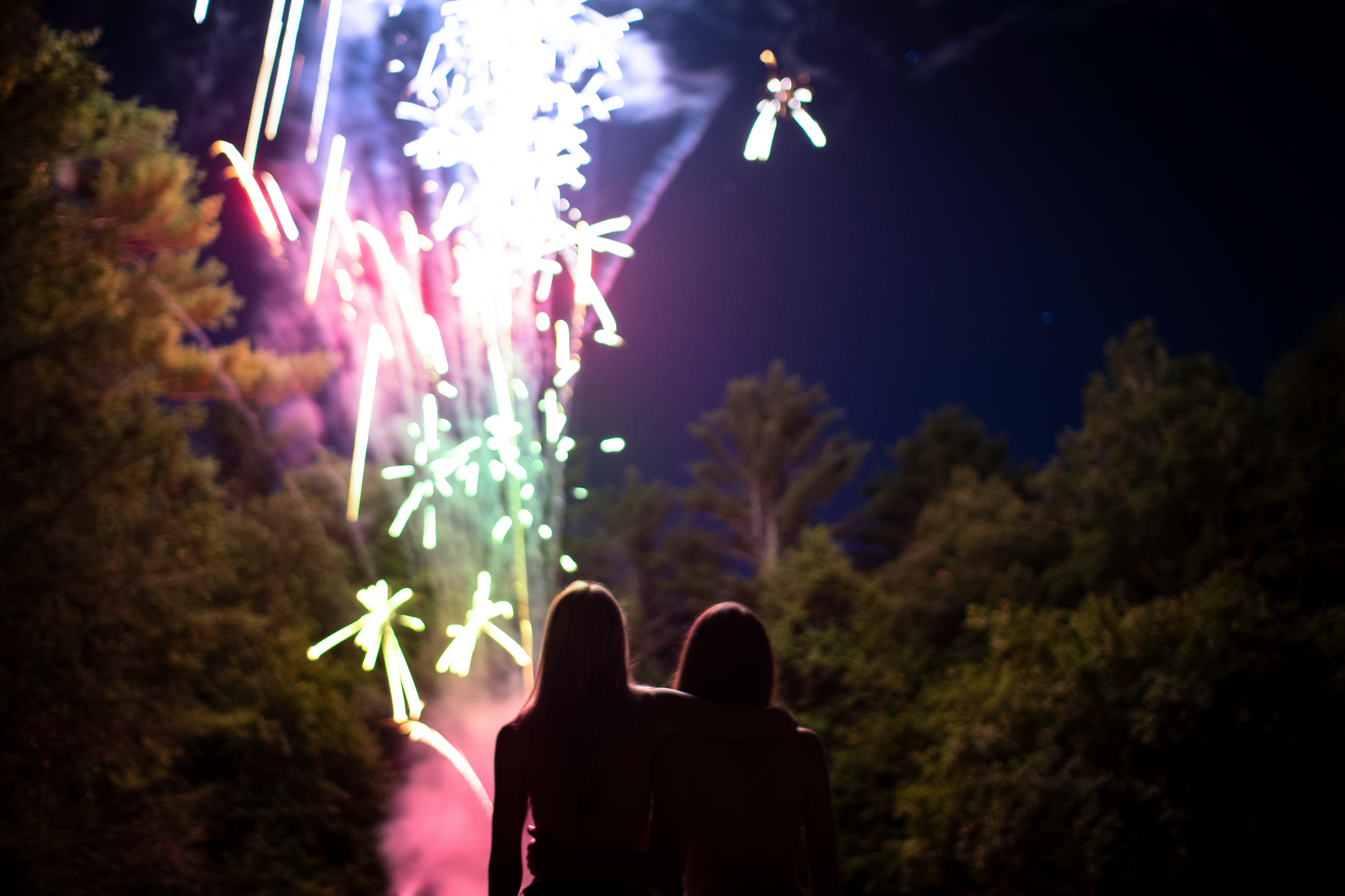 two people standing near firework show