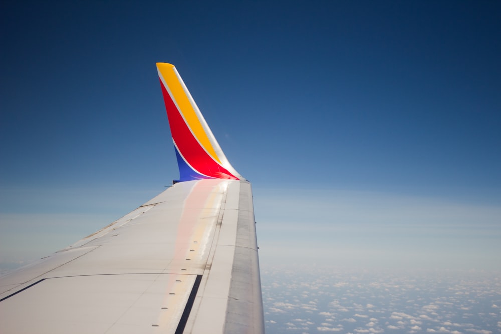 white and red airplane wing aerial photography