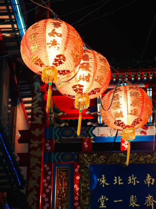 three orange hanging lanterns in Yokohama Chinatown Japan