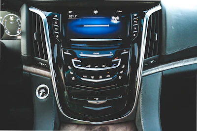 A modern car dashboard displaying a fully functional radio interface.