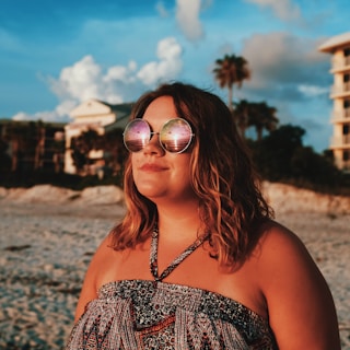 A fashionable woman enjoying a beautiful beach sunset.