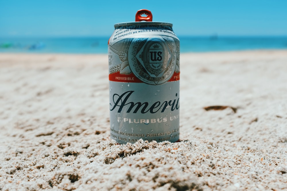 America can on brown sand near body of water