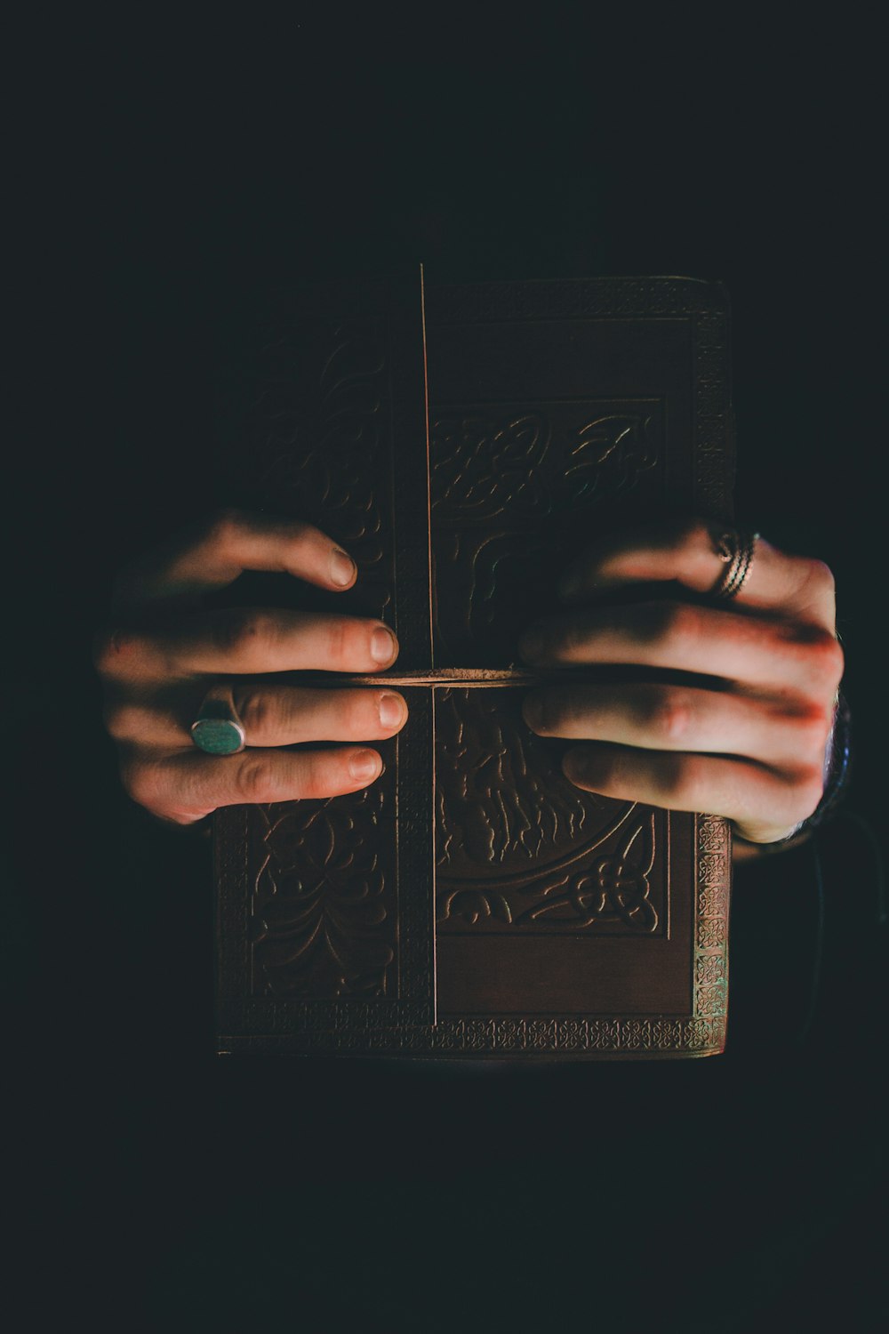 person holding hardbound book