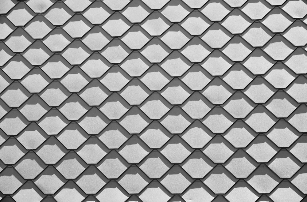 Una foto en blanco y negro de una pared hecha de azulejos hexagonales