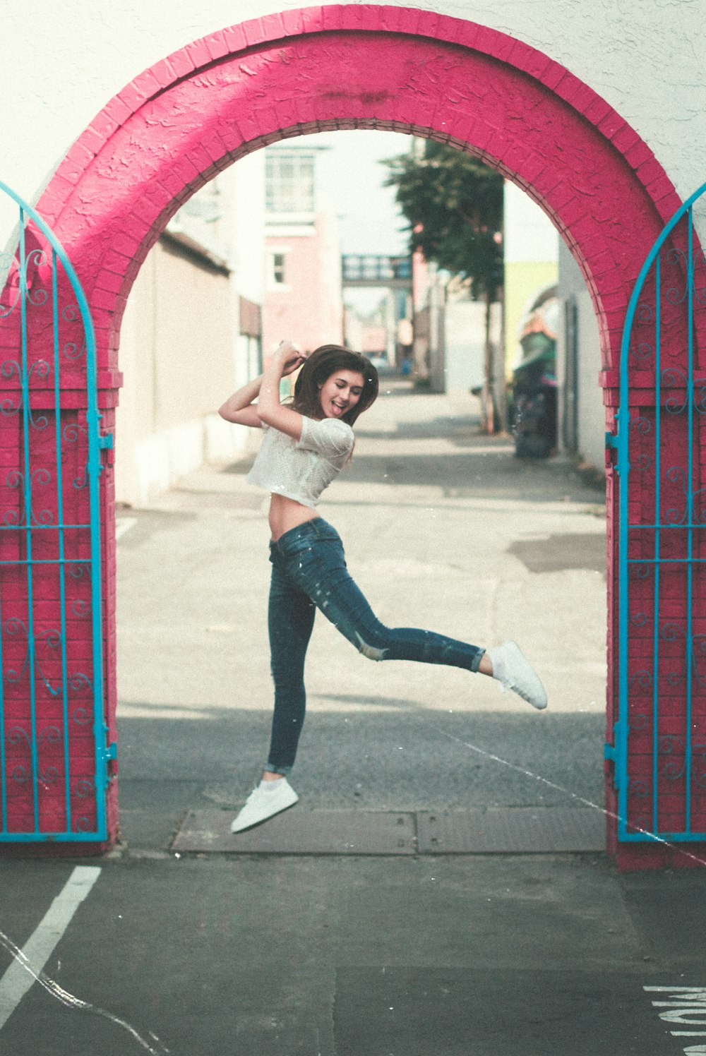 woman jumping near gate