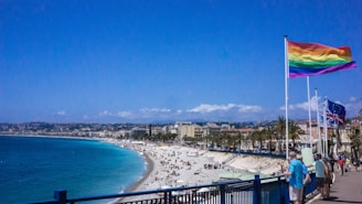A scenic beach resort with wheelchair-accessible paths and rainbow flags flying.