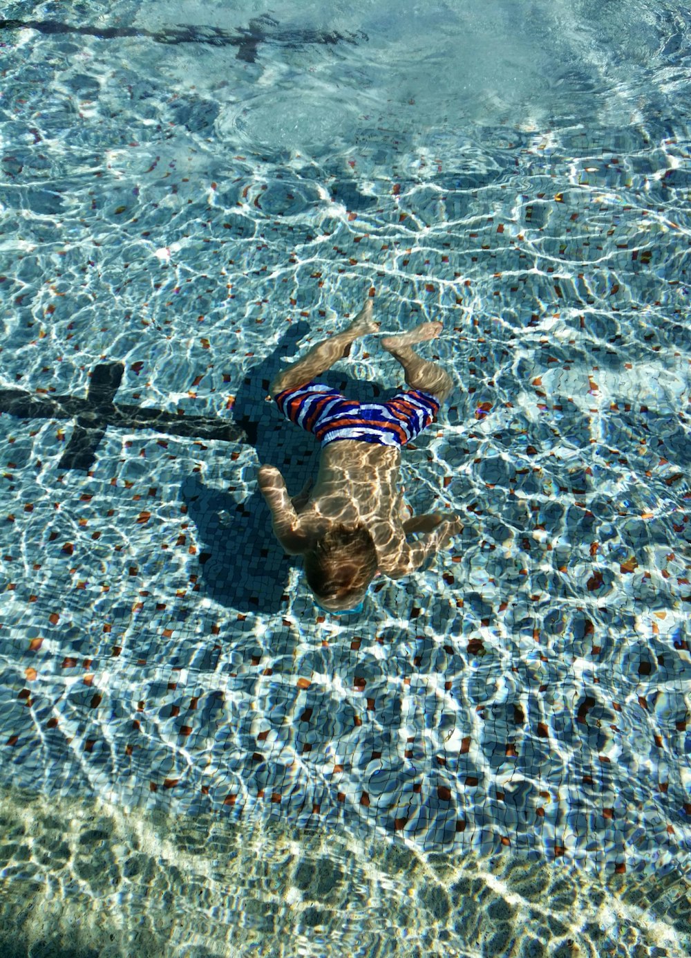 man diving on pool