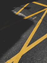 Close-up of vibrant road markings freshly painted on a busy urban street.