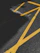 A close-up photo of freshly painted white road lines on an asphalt surface under bright sunlight.