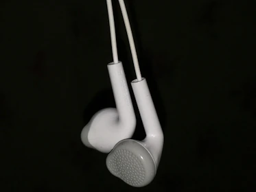 Rows of custom in-ear monitors showcasing sleek titanium shells and composite diaphragms.