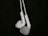 A pair of white earphones suspended against a dark background, showcasing their intricate design and smooth texture.