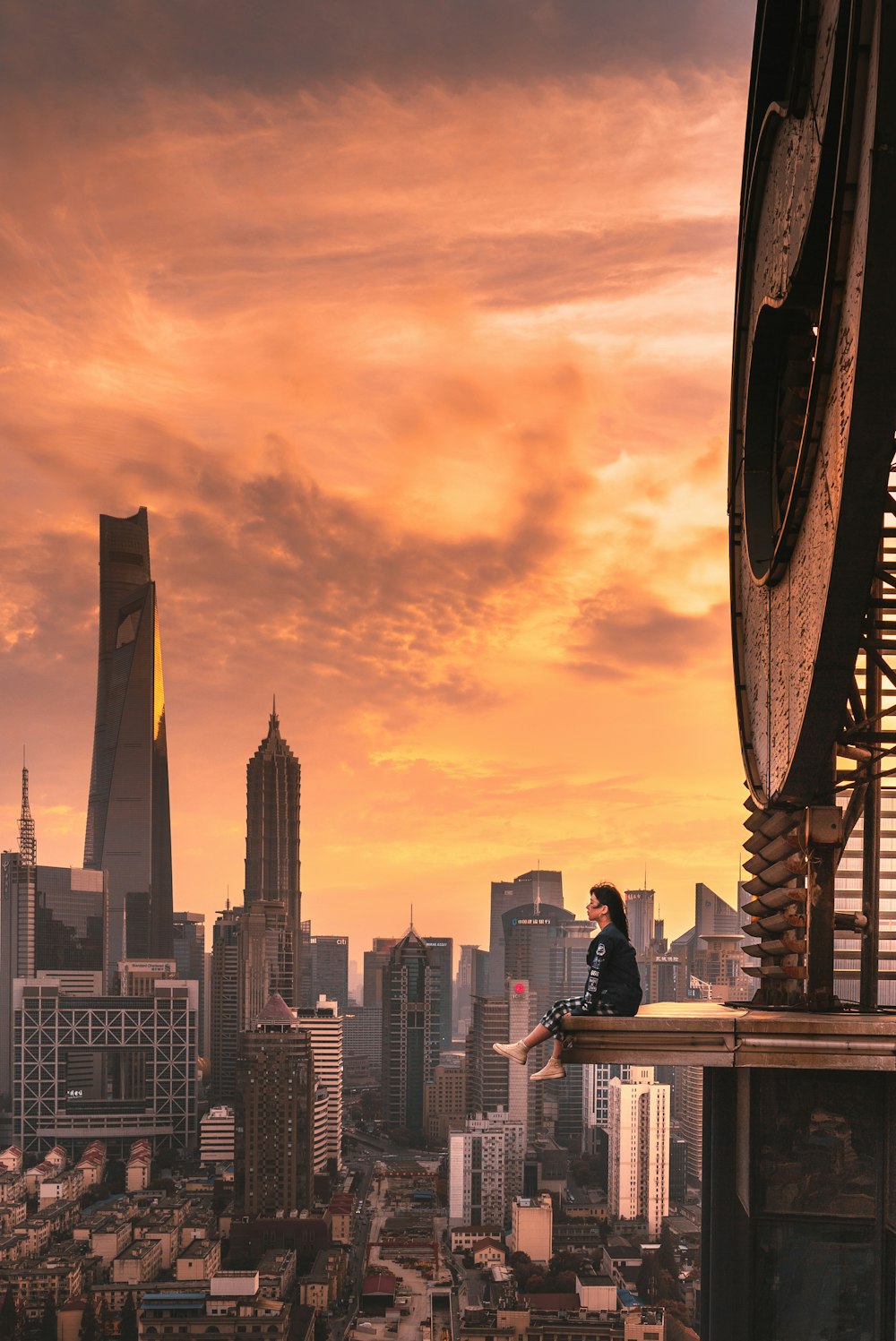 woman sitting on top of building