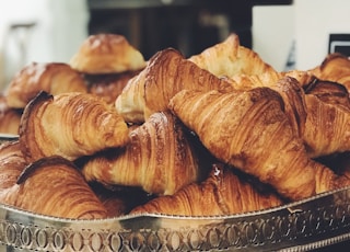 croissant on top of stainless steel tray