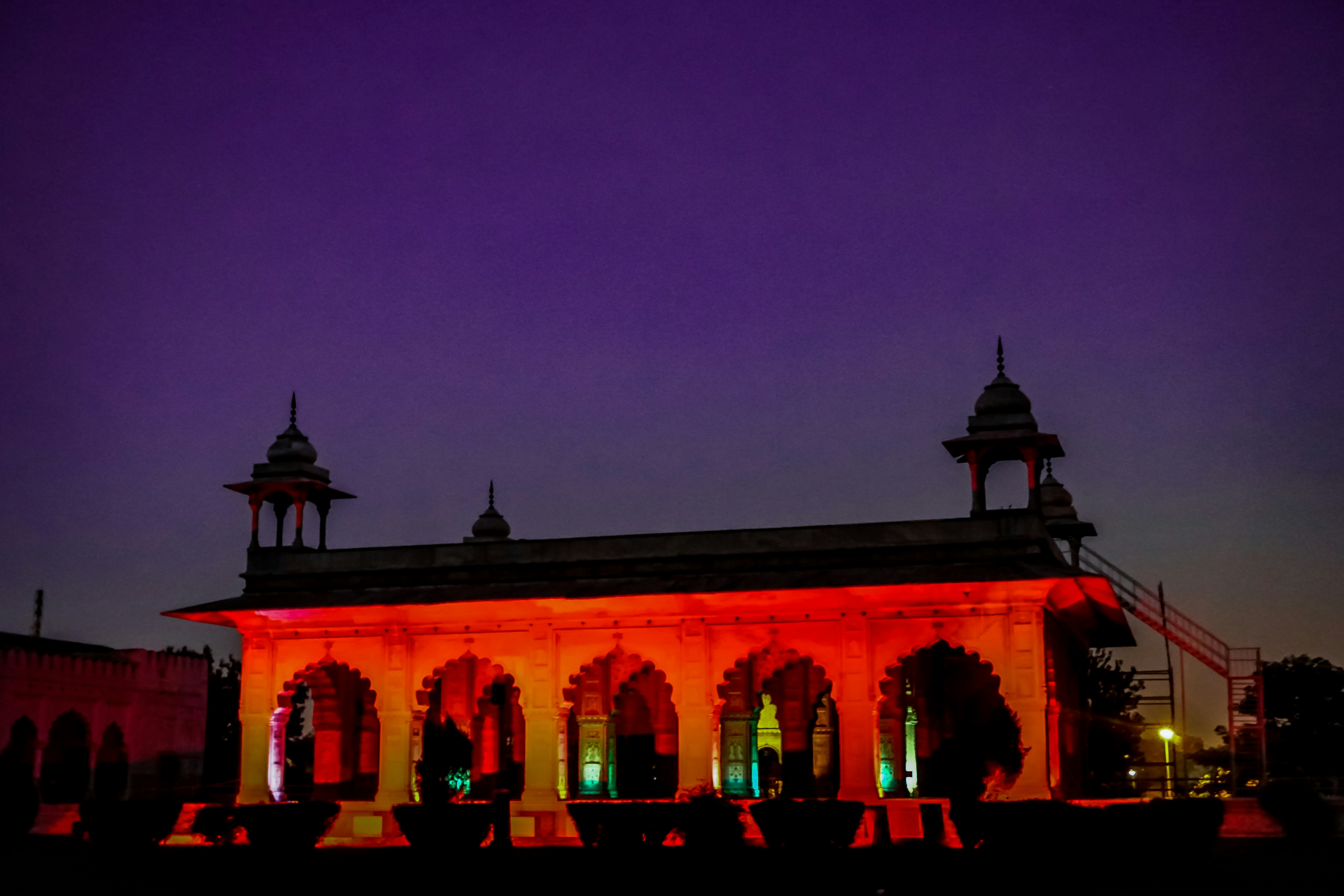 Historic architecture of the Palace of Culture illuminated at dusk.