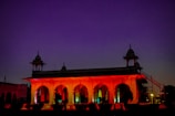 Evening view of the well-lit institute building with saffron hues in the sky.