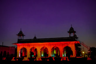 Historic architecture of the Palace of Culture illuminated at dusk.