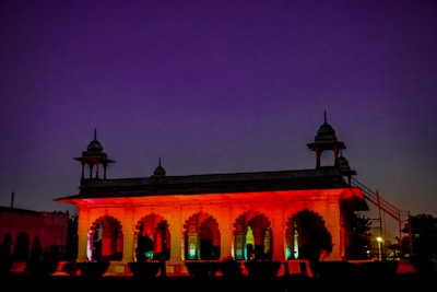 Evening view of the well-lit institute building with saffron hues in the sky.