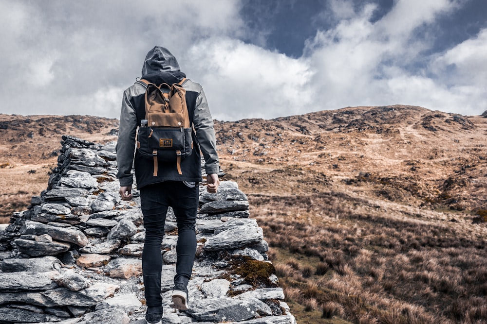 person standing on gray rock during daytime