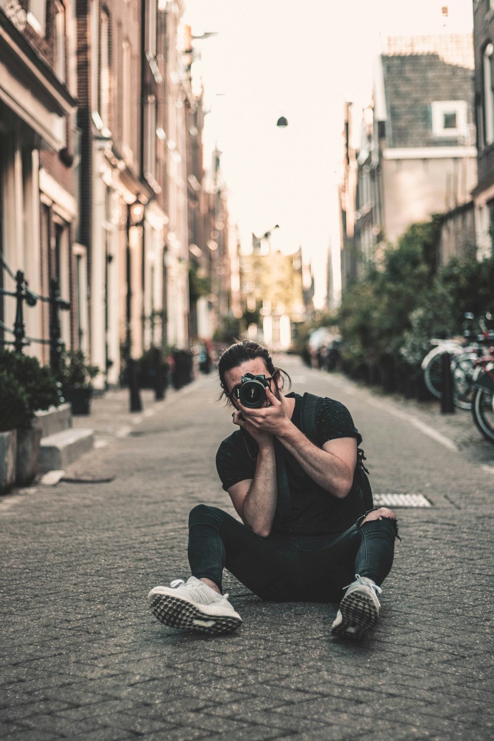 man sitting on street while talking photo