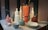 A beautifully arranged display of colorful 3D printed vases and bowls on a wooden table.
