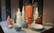A beautifully arranged display of colorful 3D printed vases and bowls on a wooden table.