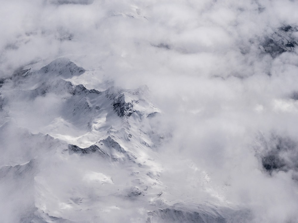 a view of the top of a mountain covered in clouds