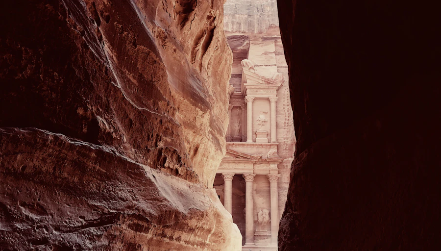 First glimpse of Petra's Treasury through the narrow walls of the Siq