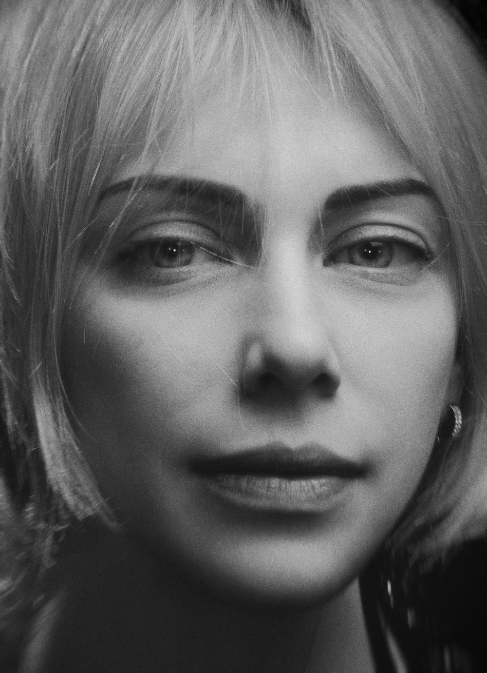 grayscale photo of woman with earring