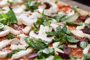Close-up of fresh basil and mozzarella cheese ready to be added to a pizza
